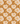 Warm-toned floral pattern with large, stylized cream flowers and golden leaves on a textured amber background featuring high absorptie, featuring the Keukendoek Splendor by Bubble & Blend.