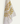 Een enkel stuk Keukendoek Whimsy Meadow Off White keukenpapier van Bubble & Blend met delicate, geschilderde illustratie van een plant met goudbruine bladeren die over de rand van een effen oppervlak hangen, bekend om zijn superieure absorptie.