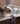 An elegant kitchen countertop adorned with a vibrant bouquet of flowers, fitted with a sleek faucet, and accentuated by a fast-drying Kitchen Towel Earthy Flora featuring Geoweave technology hanging from a drawer handle.