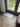 Doormat with a zebra pattern on a wooden floor in front of a glass door.
